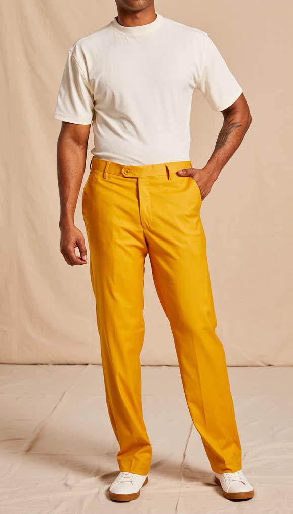 A person wearing a white t-shirt, Inserch Modern Fit Pants P3199S-38 Gold by Inserch, and white shoes stands against a beige background.