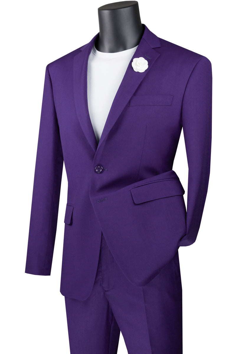 The mannequin is elegantly dressed in the Vinci Suits Slim Fit 2 Piece 2 Button Suit (Purple) SC900-12, paired with a crisp white shirt and delicate white flower lapel pin. This ensemble stands out against the white background, combining style with wrinkle-resistant convenience.