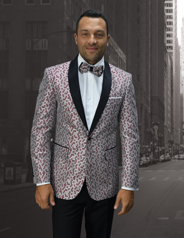 A man in a Statement Clothing jacket, style SQ-100-BURGUNDY, with a matching bow tie stands on an empty city street.