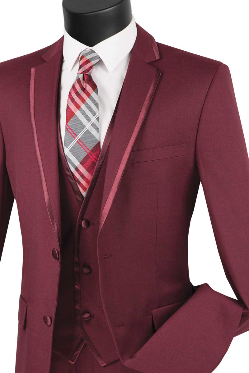 The Vinci Suits Slim Fit 2 Button 3 Piece Suit (Burgundy) SV2T-8, featuring satin lapels, is elegantly displayed on a mannequin with a crisp white shirt and plaid tie.