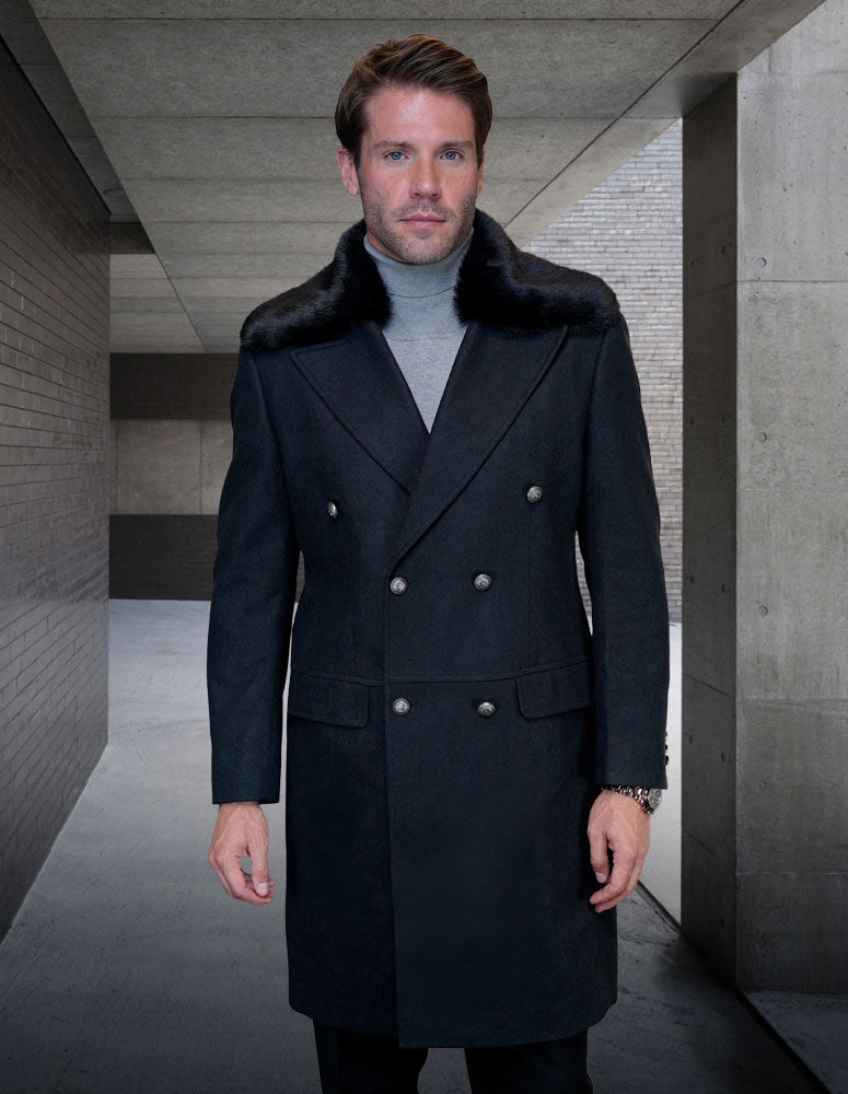 A man wearing the exquisite WJ-102-BLACK double-breasted coat by Statement Clothing, featuring a luxurious cashmere fur collar, stands in a concrete hallway.