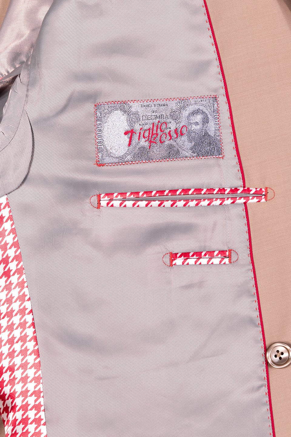 Displayed on a mannequin is the Tiglio Rosso DB Este Solid Tan Tig1004 suit, paired with a matching waistcoat, white shirt, plaid tie, and patterned pocket square. This elegant three-piece suit embodies style with its wide leg fit.