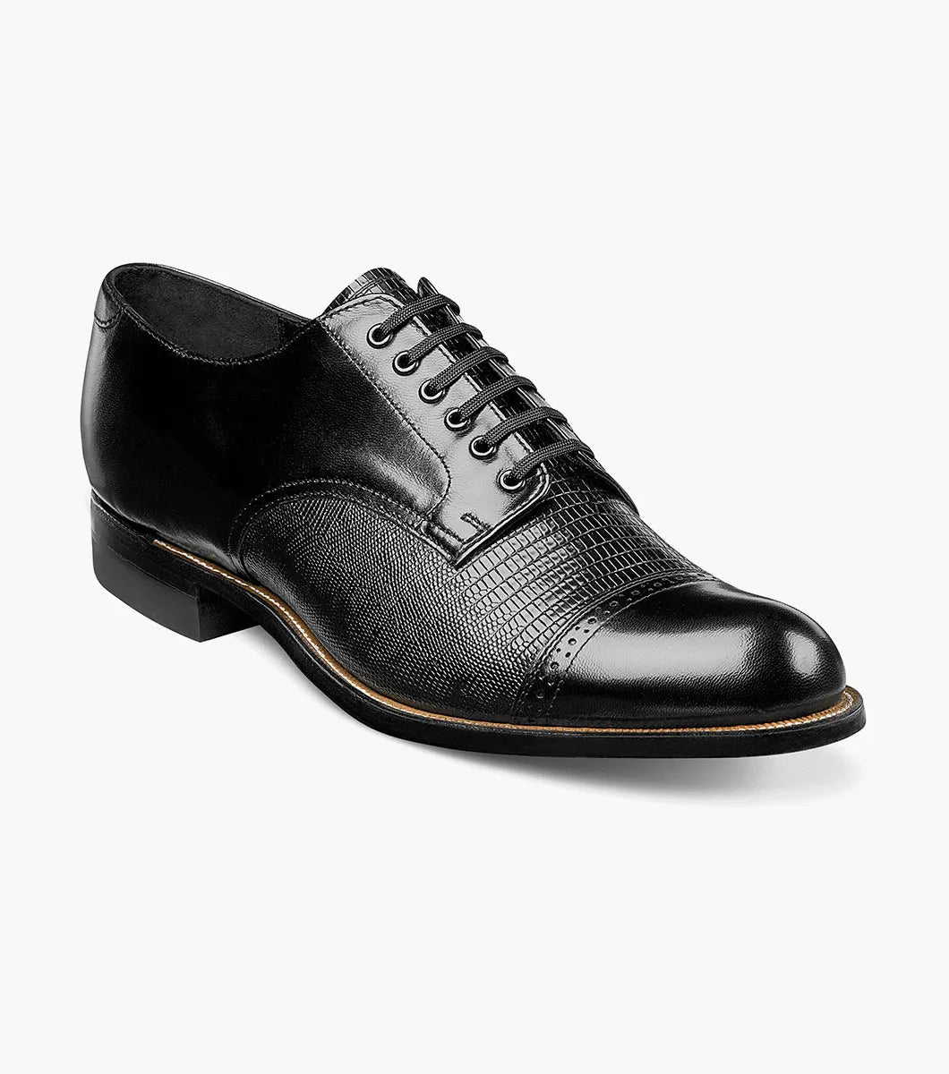 The Stacy Adams Madison Lizard Cap Toe Oxford (00049-01) is a black kidskin leather dress shoe for men, featuring a lizard print cap toe and five eyelets, shown against a white background. Brand: STACY ADAMS.