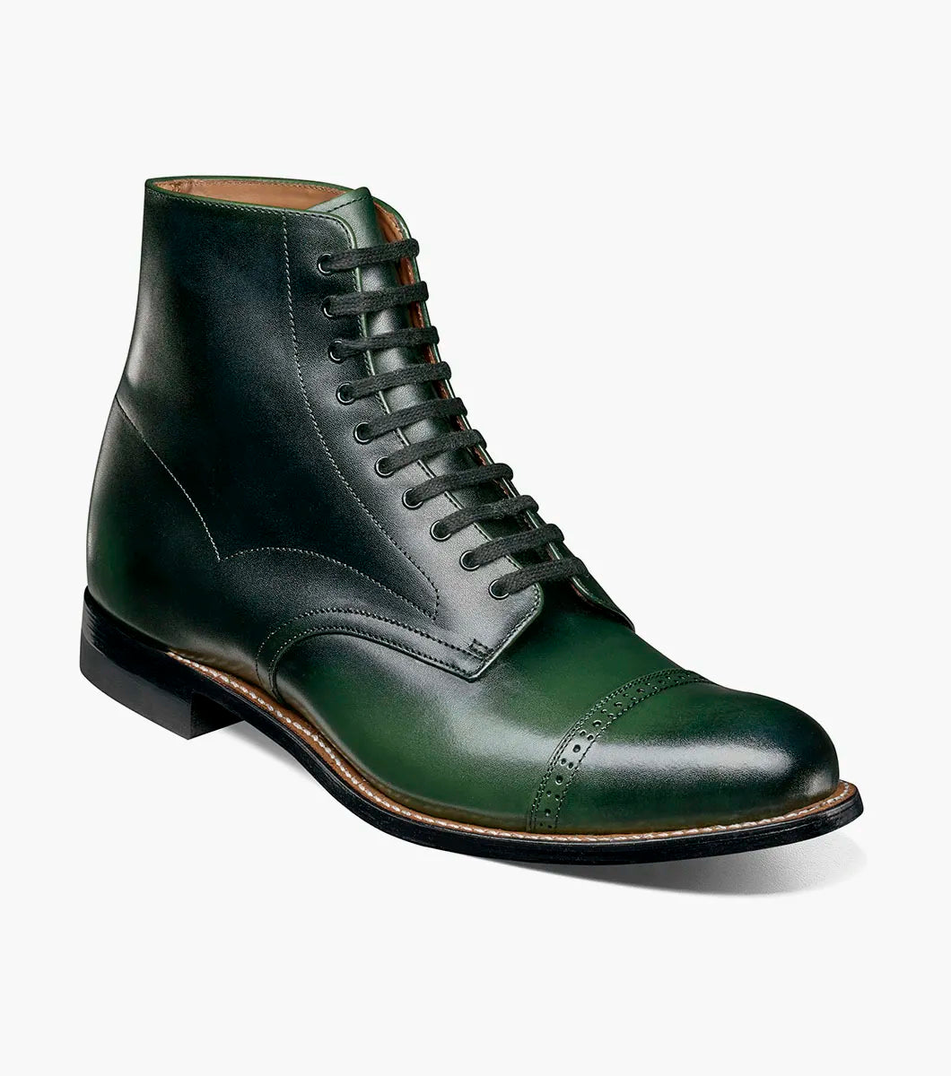 The Stacy Adams Madison Cap Toe Lace Up Boot (00110-300) features a dark green leather upper, black sole, brown welt, and closed lacing—an elegant STACY ADAMS dress boot shown on a white background.