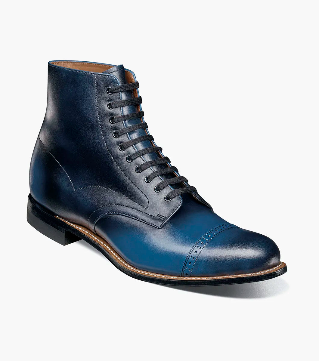 The STACY ADAMS Madison Cap Toe Lace Up Boot in blue (00110-400) is a leather dress boot with a cap toe and brogue detailing, displayed on a white background.