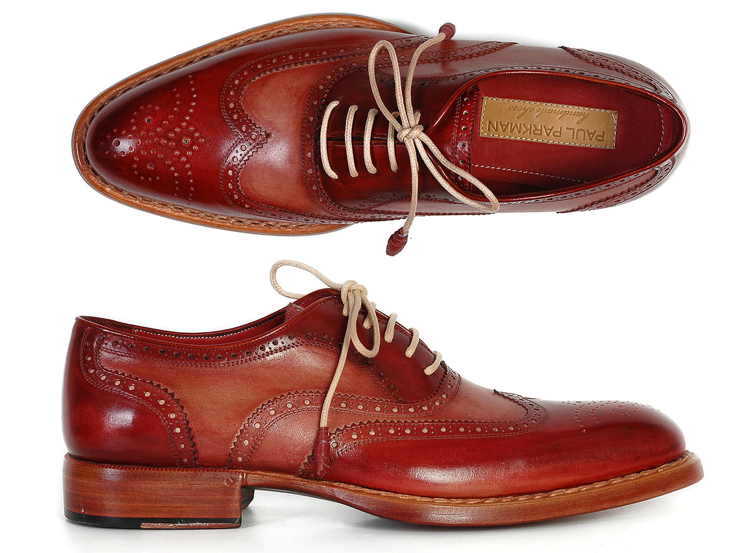 Paul Parkman Wingtip Oxfords Bordeaux & Camel - 027B are handmade brown leather shoes with decorative perforations, beige laces, and wooden soles, shown in top and side views. Brand: Paul Parkman.