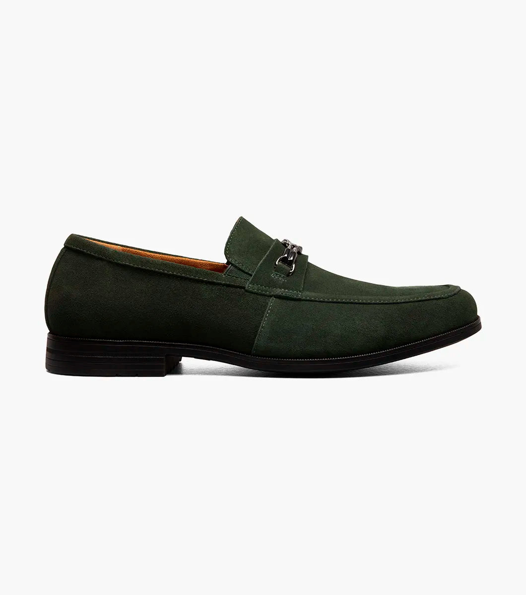 The STACY ADAMS Ravelle Moc Toe Bit Slip On in Washed Green (25680-344) is a green suede loafer with a low heel, metal bit detail, and cushioned footbed for comfort, displayed on a plain white background.