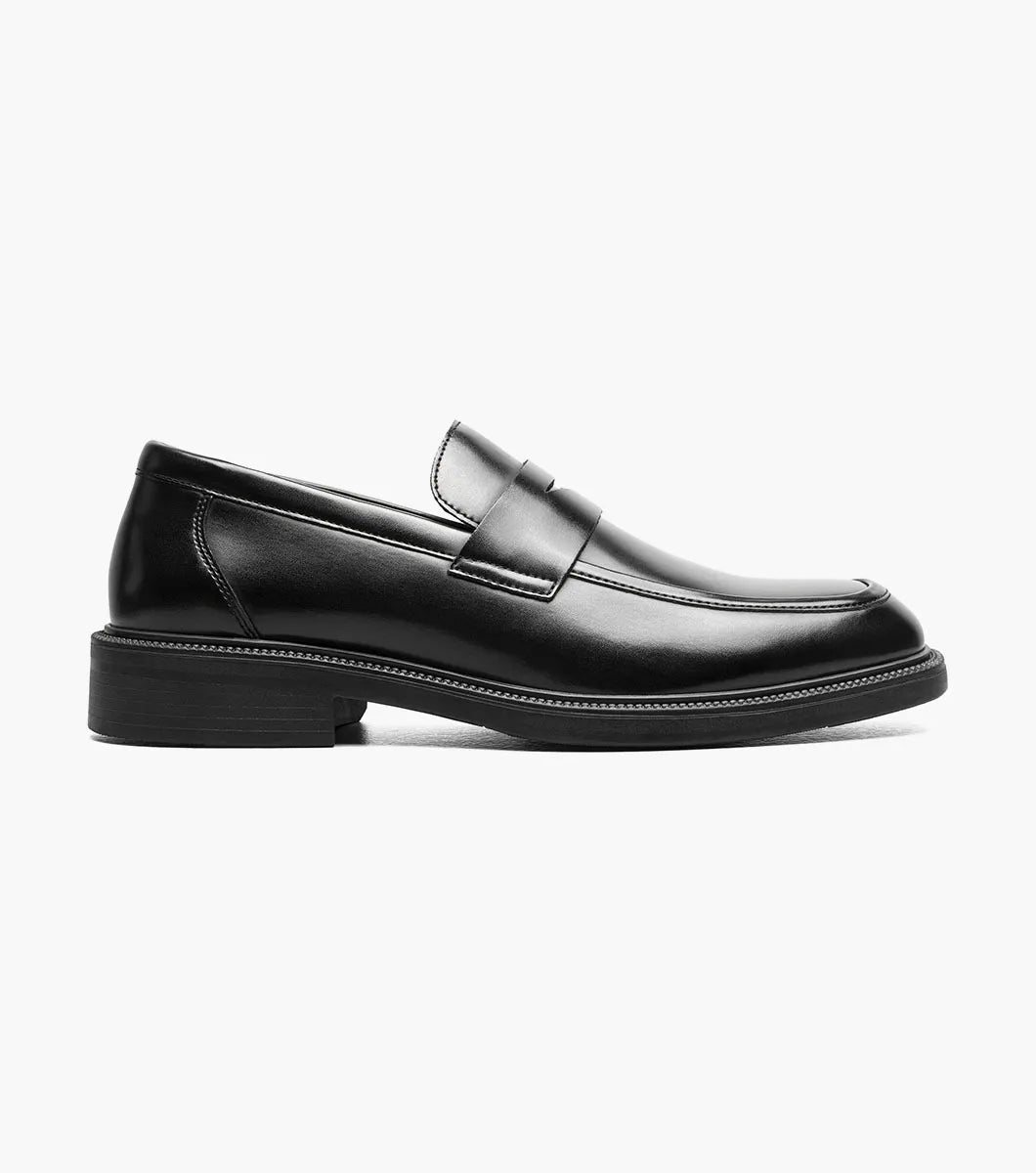 The STACY ADAMS Everett Moc Toe Penny Slip On (style 25790-001) is a single black leather loafer featuring a low heel, polished finish, moc toe stitching detail, and a cushioned insole for enhanced comfort, shown against a plain white background.
