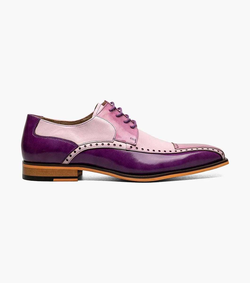 The STACY ADAMS Plaza Modified Cap Toe Oxford (25608-540) is a men's dress shoe featuring a pointed toe, leather upper in purple and pink gradient, decorative perforations, and a light brown sole.