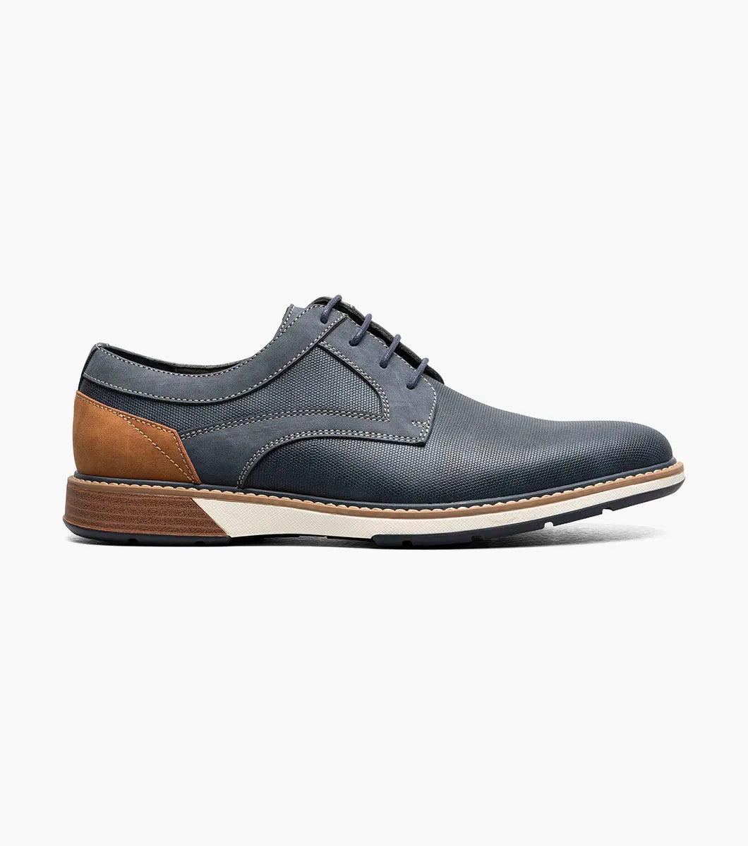 The Stacy Adams Phineas Plain Toe Oxford in navy features tan heel and sole accents, a textured upper, lace-up closure, and cushioned insole for comfort.