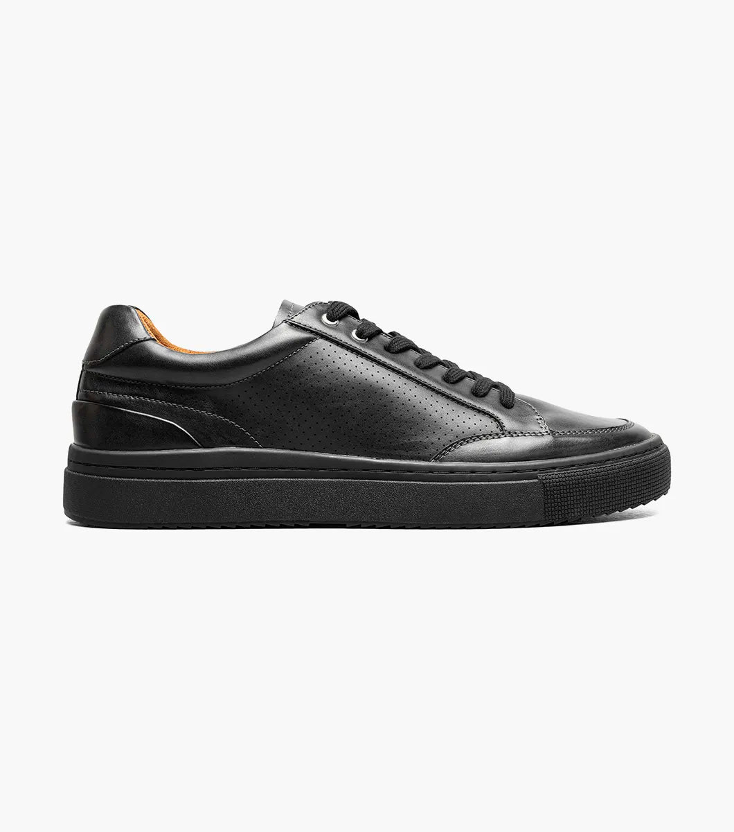 The STACY ADAMS Dorian Lace To Toe Sneaker (Black Smooth, style 25749-005) features a smooth black leather low-top design with black laces, a black rubber sole, and brown lining. It offers anatomical arch support and includes a RedZone removable footbed, shown against a plain white background.