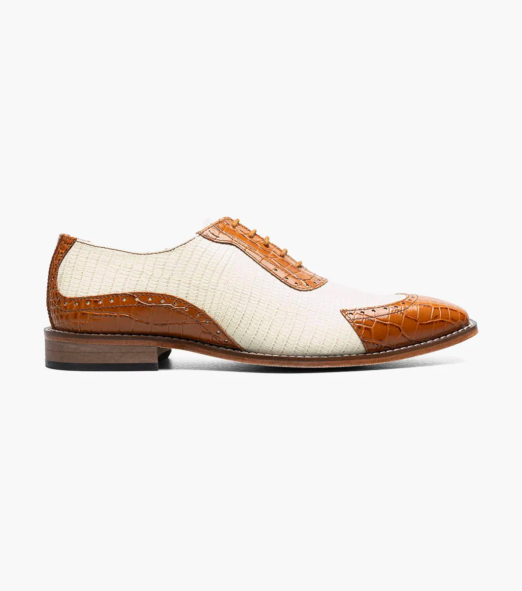 The STACY ADAMS Tarango Modified Cap Toe Oxford in Tan Multi (25770-238) blends tan leather and cream fabric with a closed lace design and low wooden heel—an ideal formal shoe for stylish men.