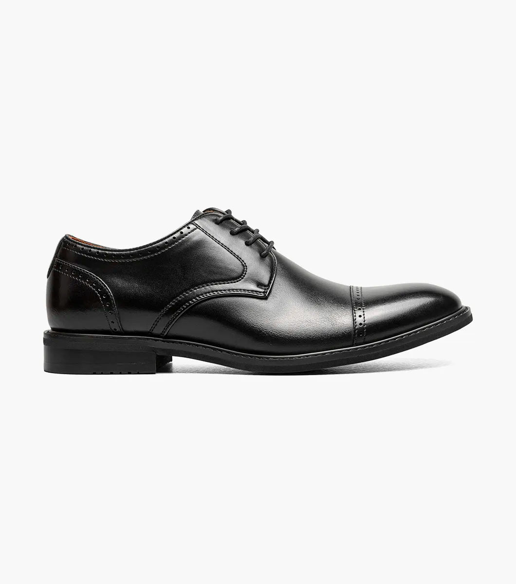 The Stacy Adams Bailey Cap Toe Oxford (25750-001) is a black leather dress shoe with laces, stitched detailing, and anatomical arch support, shown on a white background.