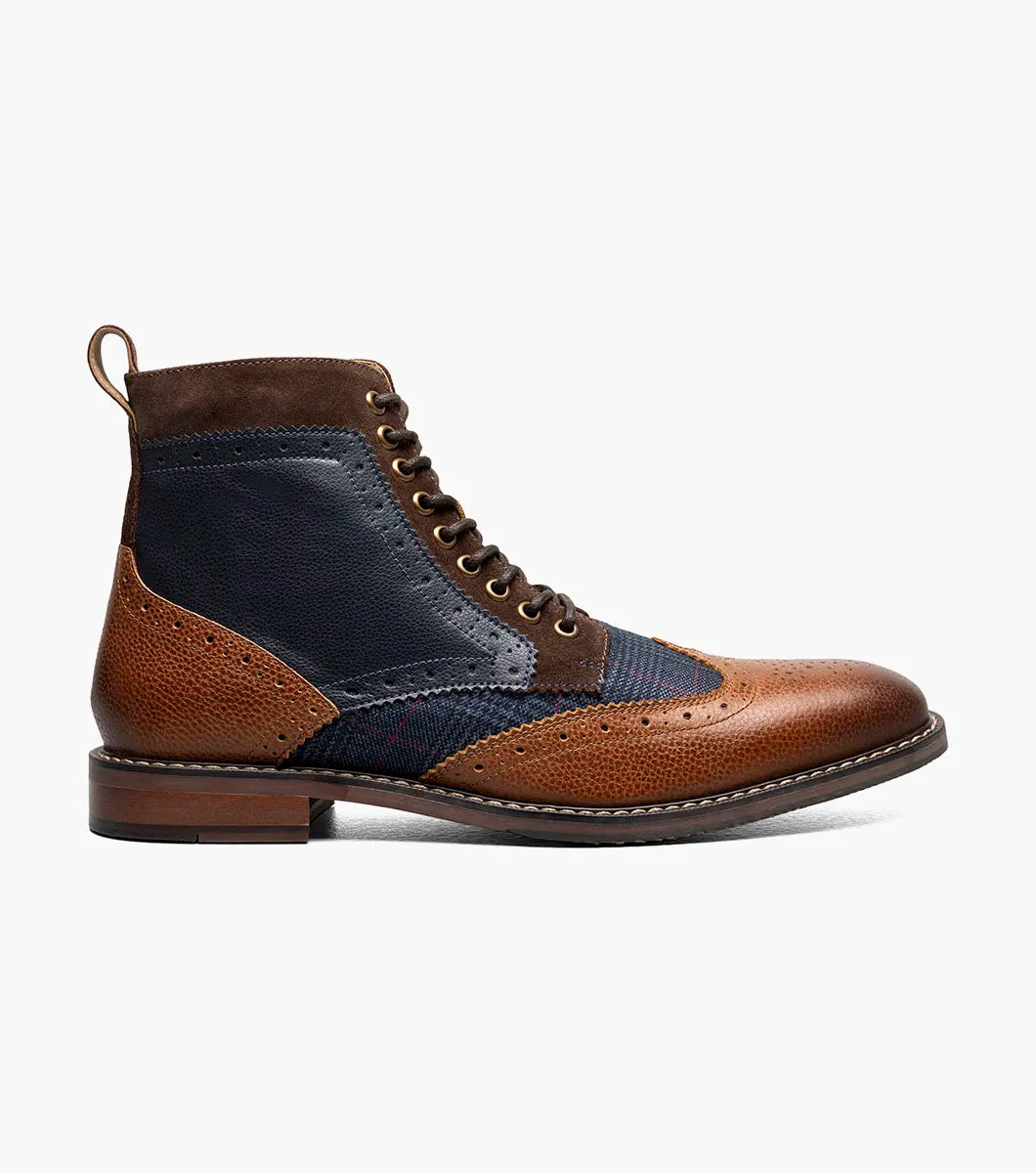 The STACY ADAMS Finnegan Wingtip Lace Up Boot (Cognac with Navy, 25427-470) features two-tone leather, brogue details, and a low heel—ideal for those seeking stylish and comfortable footwear. Shown in left profile on a white background.