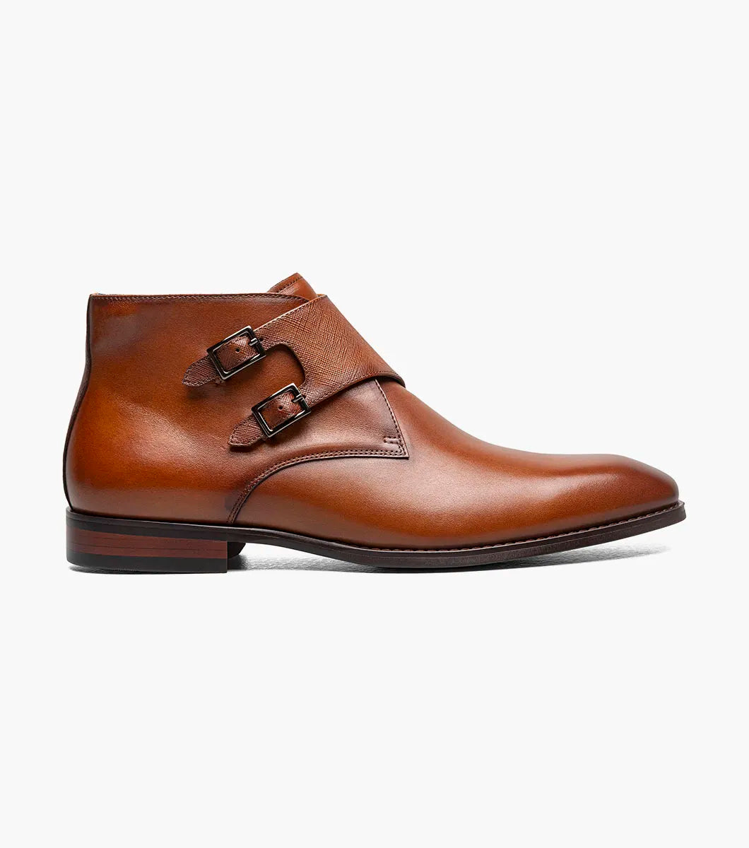 The STACY ADAMS Kaius Plain Toe Double Monk Strap Boot in Cognac (25733-221) features hand-burnished leather, a textured side panel, low stacked heel, and anatomical arch support, shown on a white background.