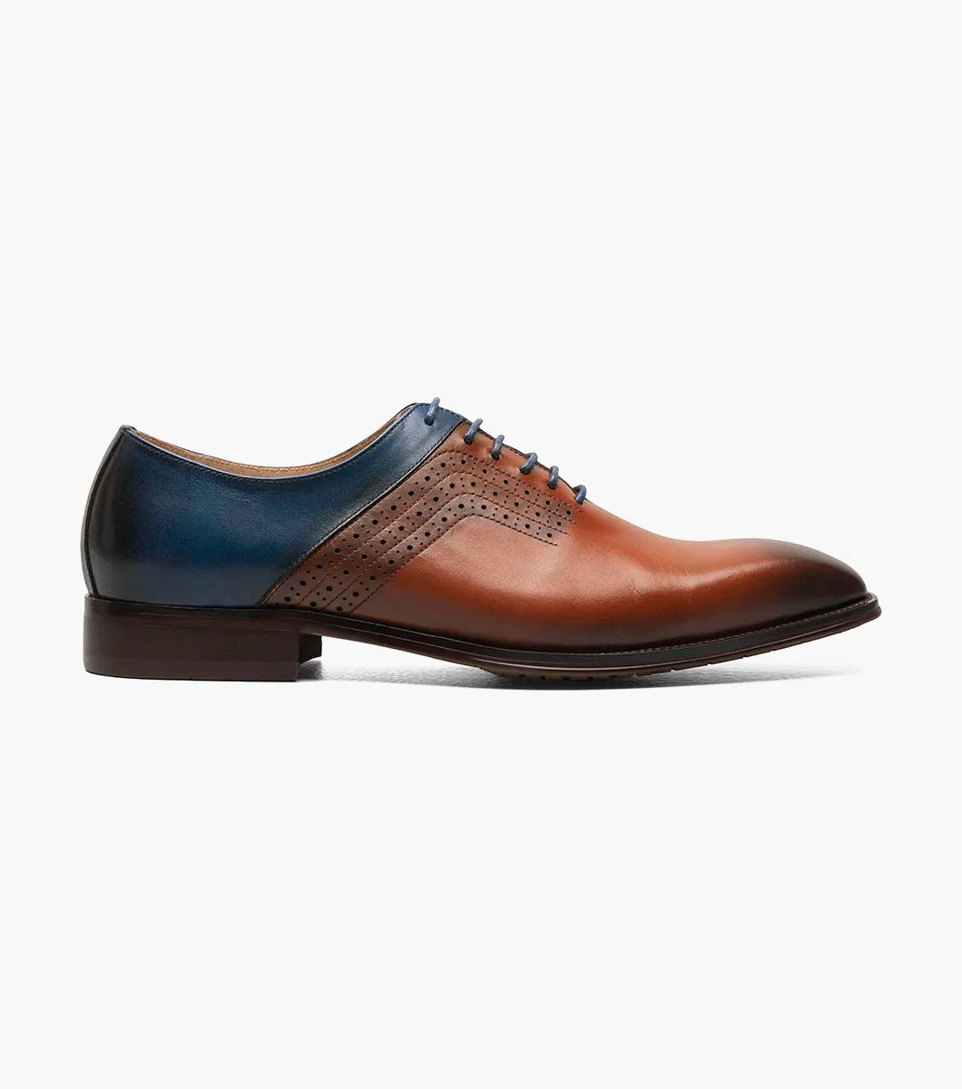 The Stacy Adams Halloway Plain Toe Oxford in Cognac Multi (25585-229) features leather construction with closed lacing and decorative perforations, showcased against a white background.