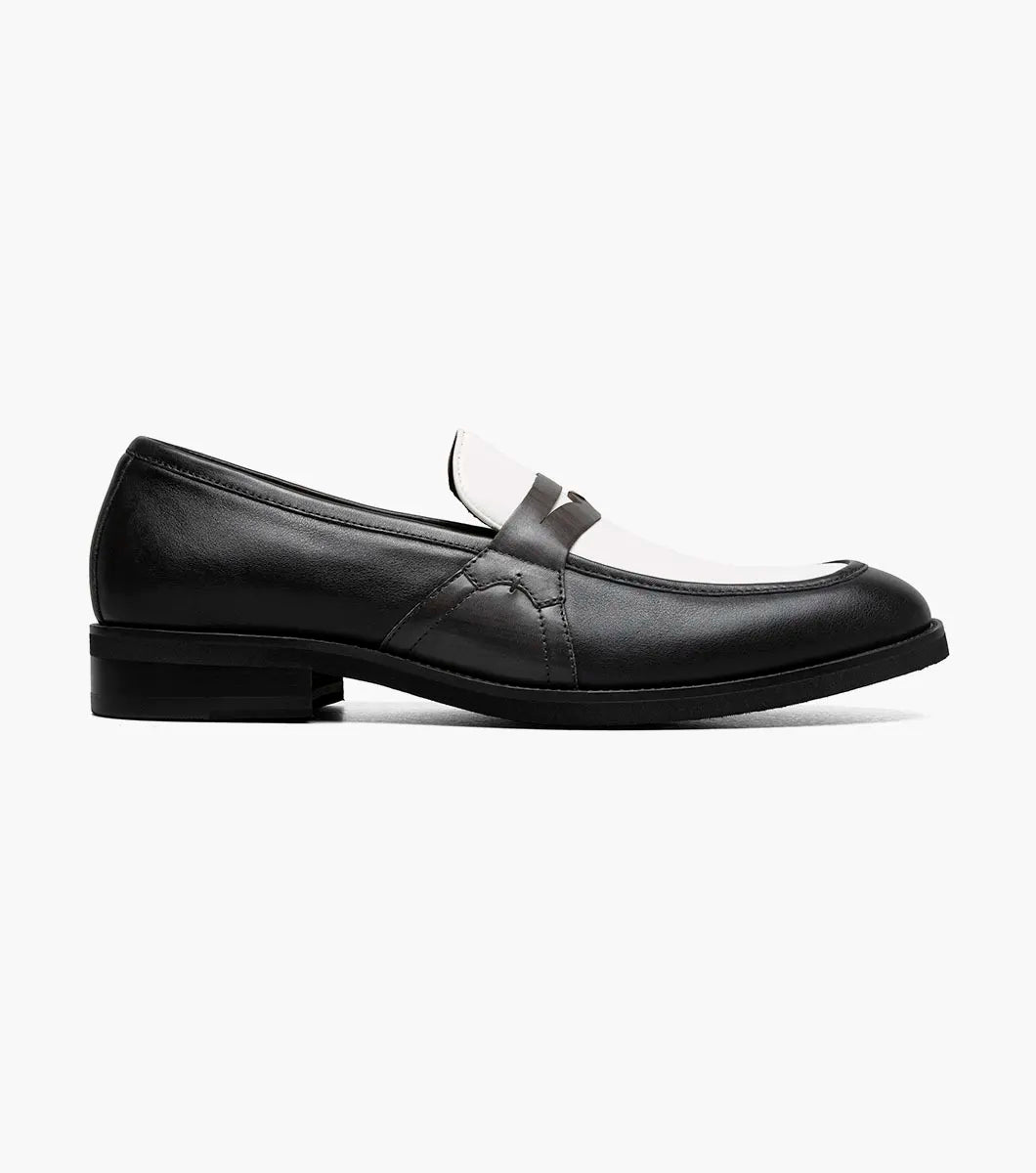 The Stacy Adams Prichard Moc Toe Penny Slip On features a black and grey leather upper with a low heel, shown from the side against a plain white background. Brand: STACY ADAMS. Style: 25693-910.