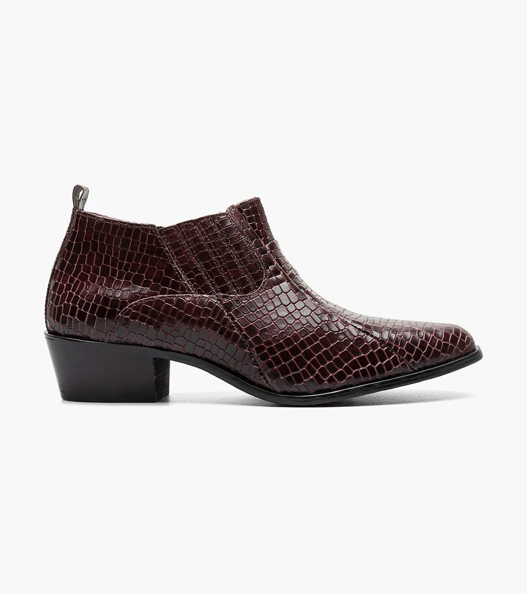 The STACY ADAMS Sandoval Cuban Heeled Boot in Burgundy (25666-601) is a single maroon ankle boot with a low Cuban heel, shiny crocodile print texture, side stretch panels, and a cushioned footbed for comfort.