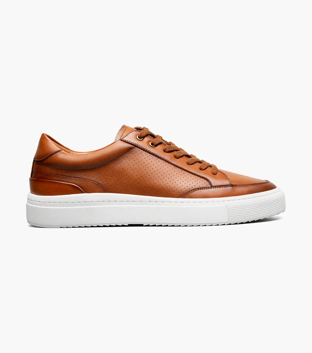 The Stacy Adams Dorian Moc Toe Lace Up in Cognac (25749-221) features brown leather, moc toe lace up design with matching laces, removable footbed, and a white rubber sole. Shown on a plain white background.