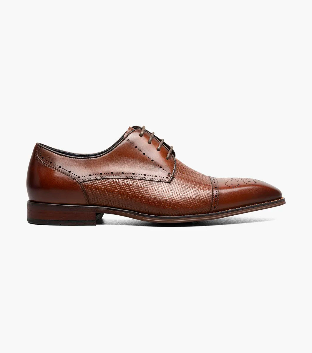 The Stacy Adams Silsbury Cap Toe Oxford in Cognac features decorative toe perforations, textured upper detailing, lace-up closure, low heel, and a memory foam footbed for comfort.