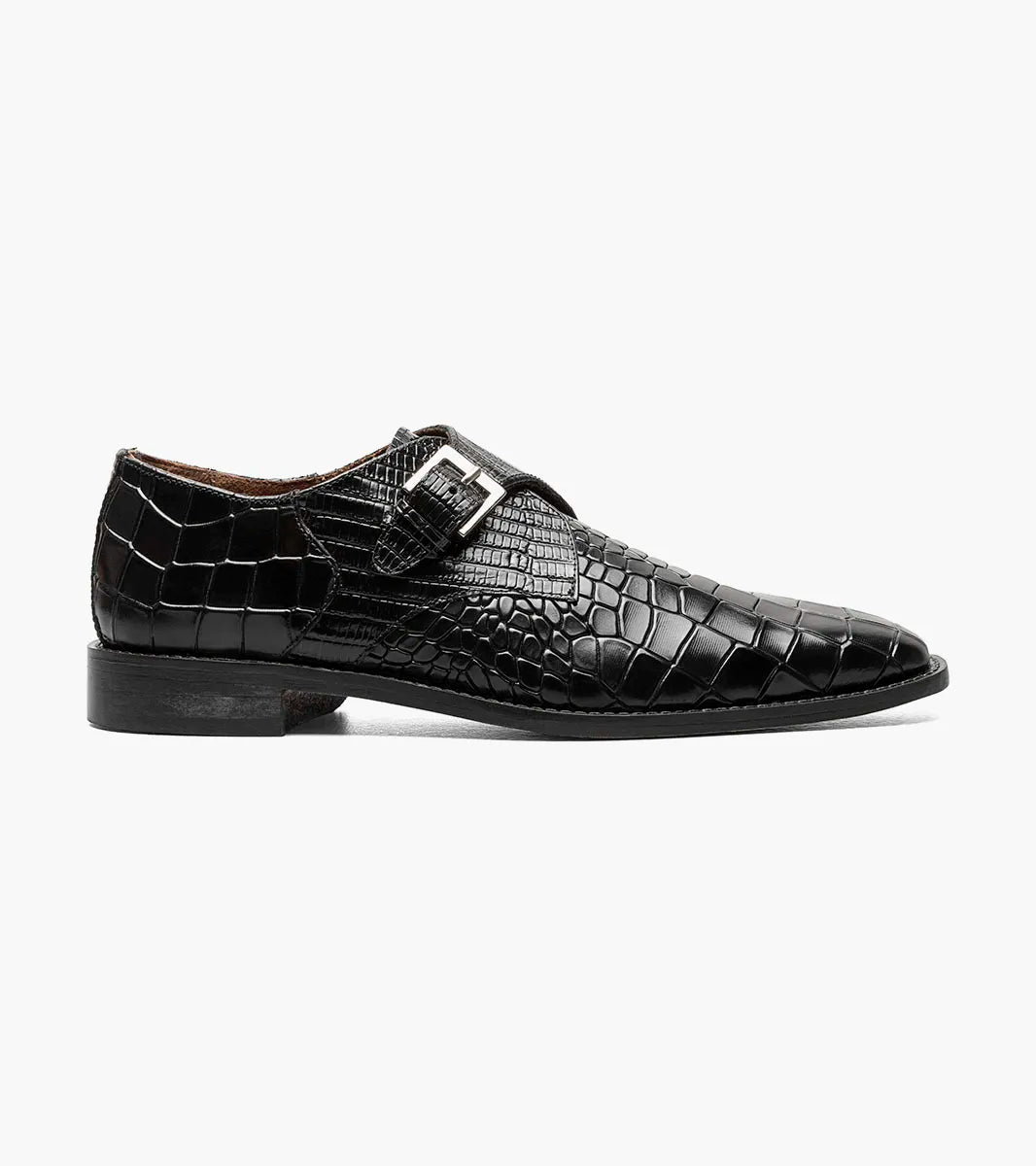 The Stacy Adams Rapino Plain Toe Monk Strap in black features crocodile print leather, a single monk strap with silver buckle, low heel, and RedZone footbed, shown on a white background.