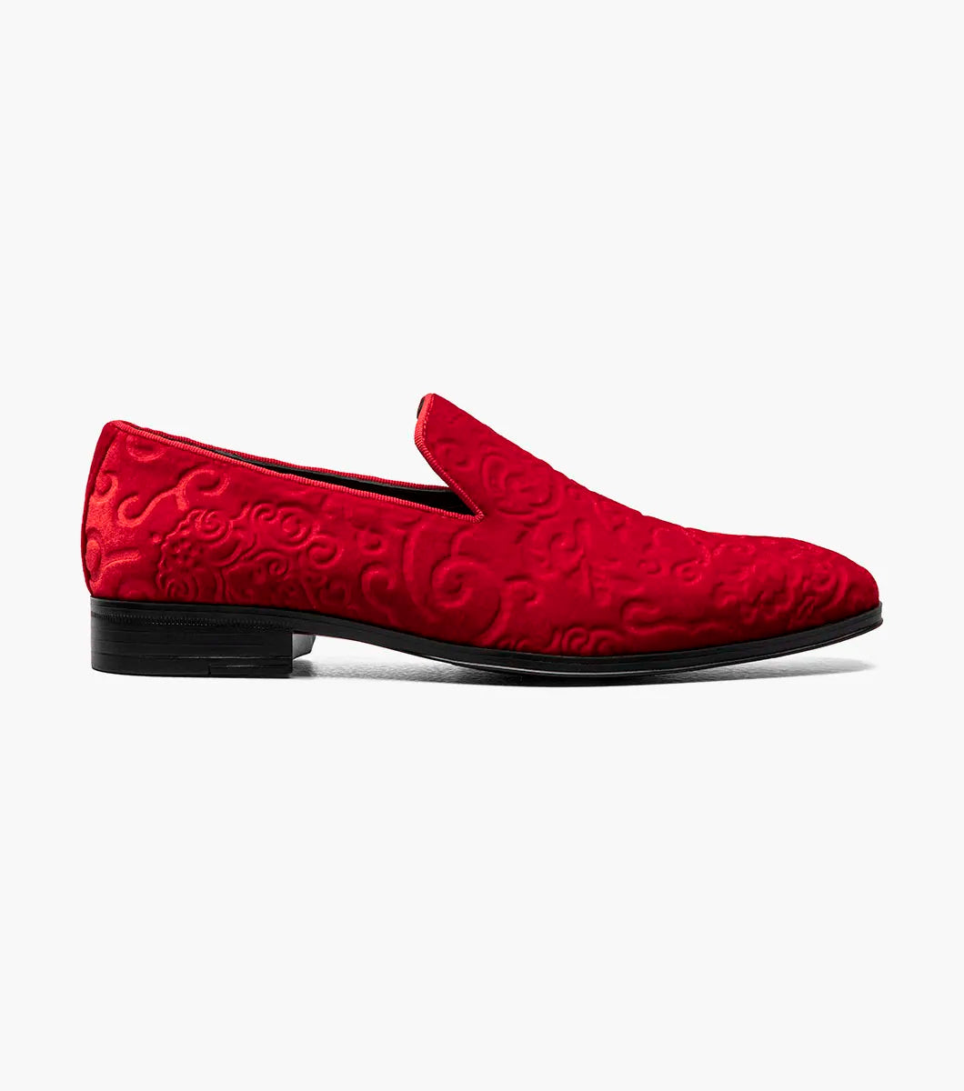 The Stacy Adams Saunders Debossed Velour Slip On in red (25581-600) features swirling embossed patterns, a black sole, and a cushioned insole for comfort.