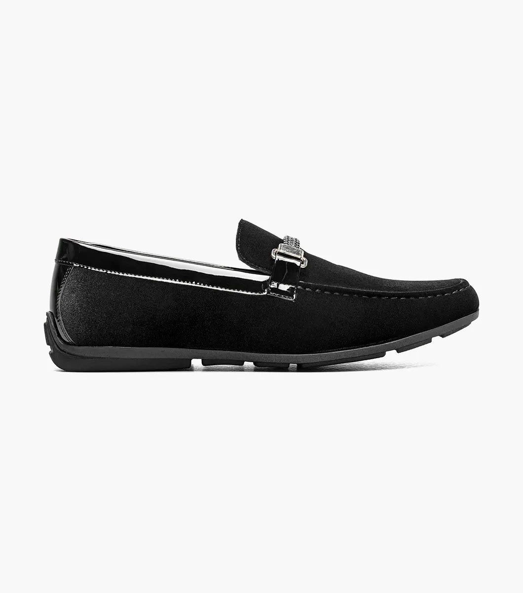 The Stacy Adams Sheridan Moc Toe Bit Slip On (black, 25761-001) is a sleek black suede dress shoe with braided detail and metal accent, low heel, and satin-lined interior for comfort.