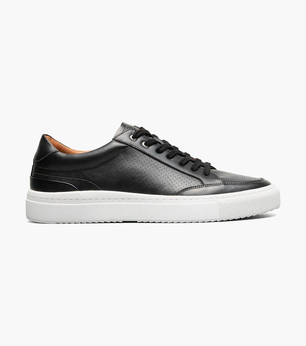 The STACY ADAMS Dorian Moc Toe Lace Up (25749-001) is a black leather court shoe with black laces, tan interior lining, arch support, and a thick white rubber sole, shown on a plain white background.