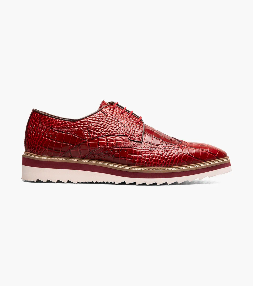 The Stacy Adams Alario Wingtip Oxford (25725-600) in red features crocodile print leather, brogue detailing, a white and tan EVA sole, and brown lining, shown on a plain white background.