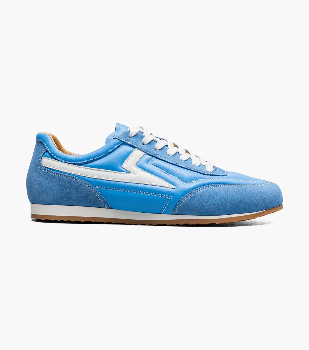 The STACY ADAMS Action 150 Sporty Lace Up in blue (style 25797-400) features white accents, white laces, and a suede toe. This low-top sneaker is showcased against a plain white background.