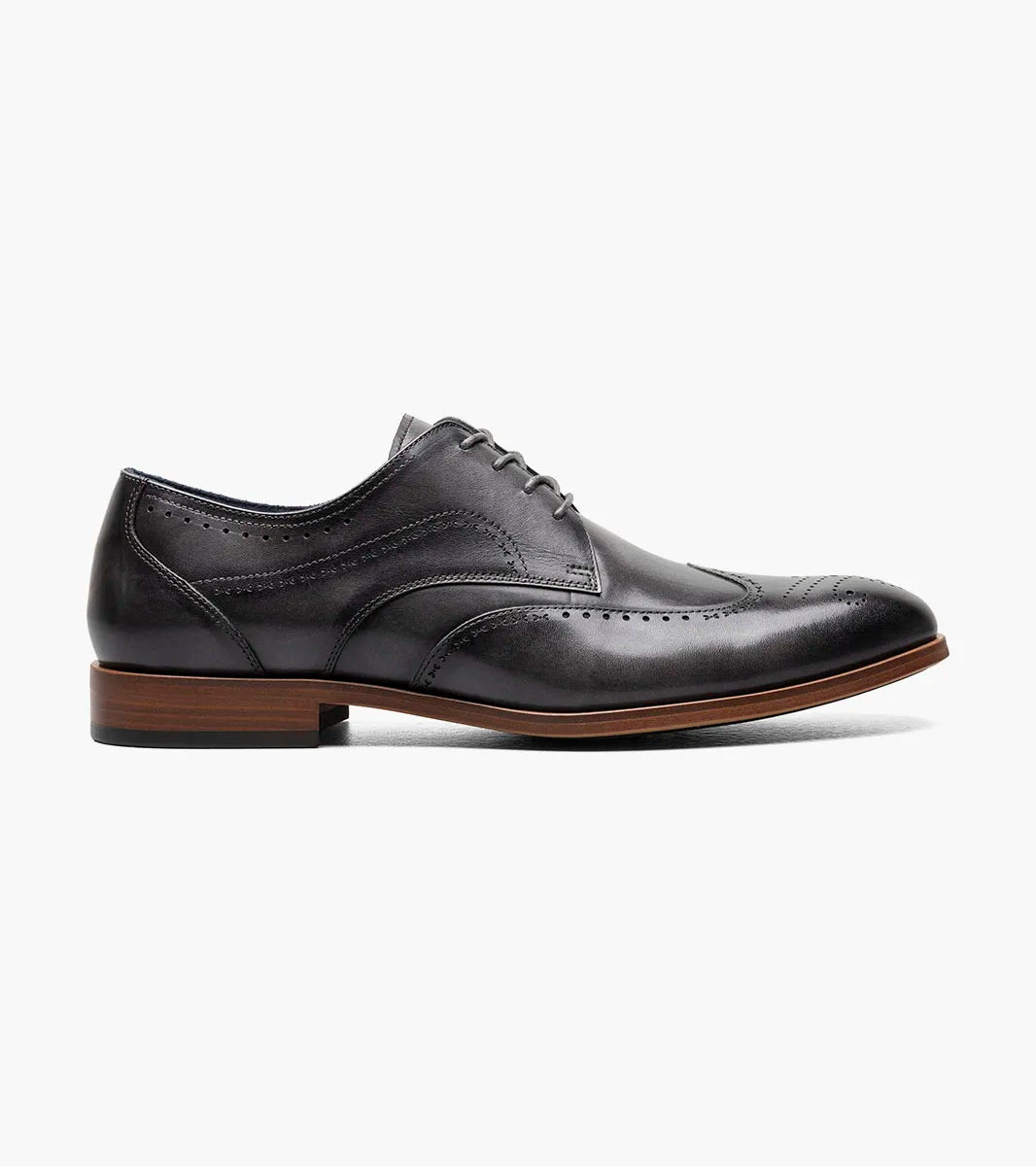 The STACY ADAMS Brayden Wingtip Oxford in gray (25635-020) features brogue detailing, a lace-up closure, and a brown sole, shown individually on a white background.