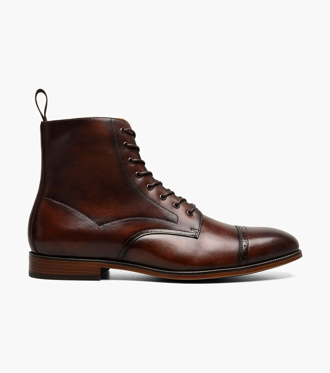 The STACY ADAMS Henry Cap Toe Lace Up Boot in brown (25718-200) features a leather upper, cap toe, decorative stitching, back pull tab, and anatomical arch support; shown on a white background.