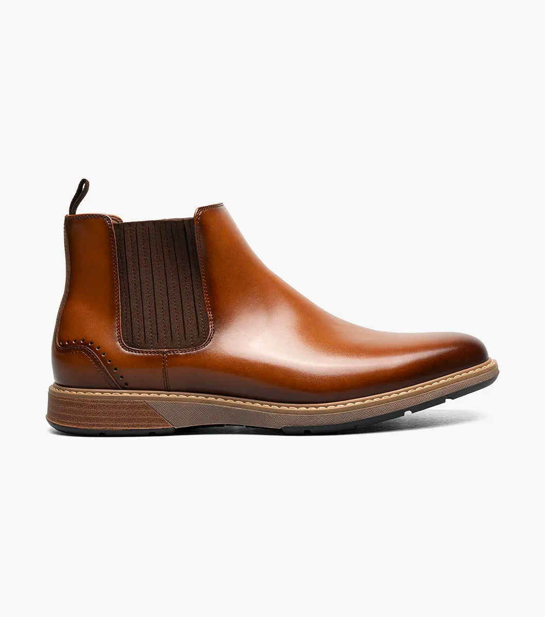 The Stacy Adams Platt Plain Toe Chelsea Boot in cognac features elastic side panels, a back pull tab, low stacked heel, and a RedZone removable footbed; shown on a white background.