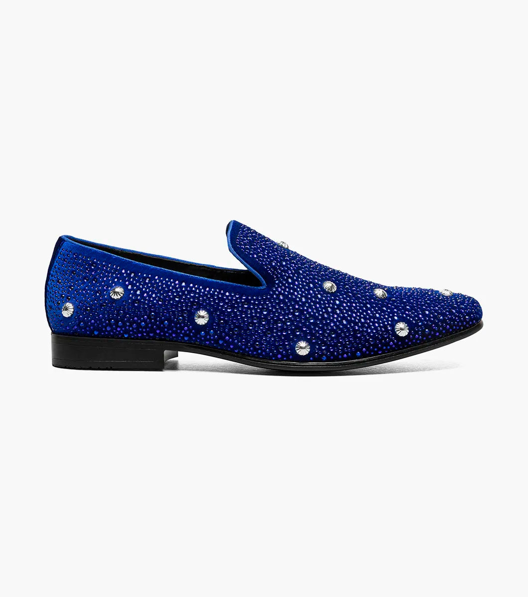 The Stacy Adams Spangle Rhinestone Slip On (Royal, 25699-432) by STACY ADAMS, features satin fabric with small rhinestones and large round gems. The loafer is displayed in profile against a white background.