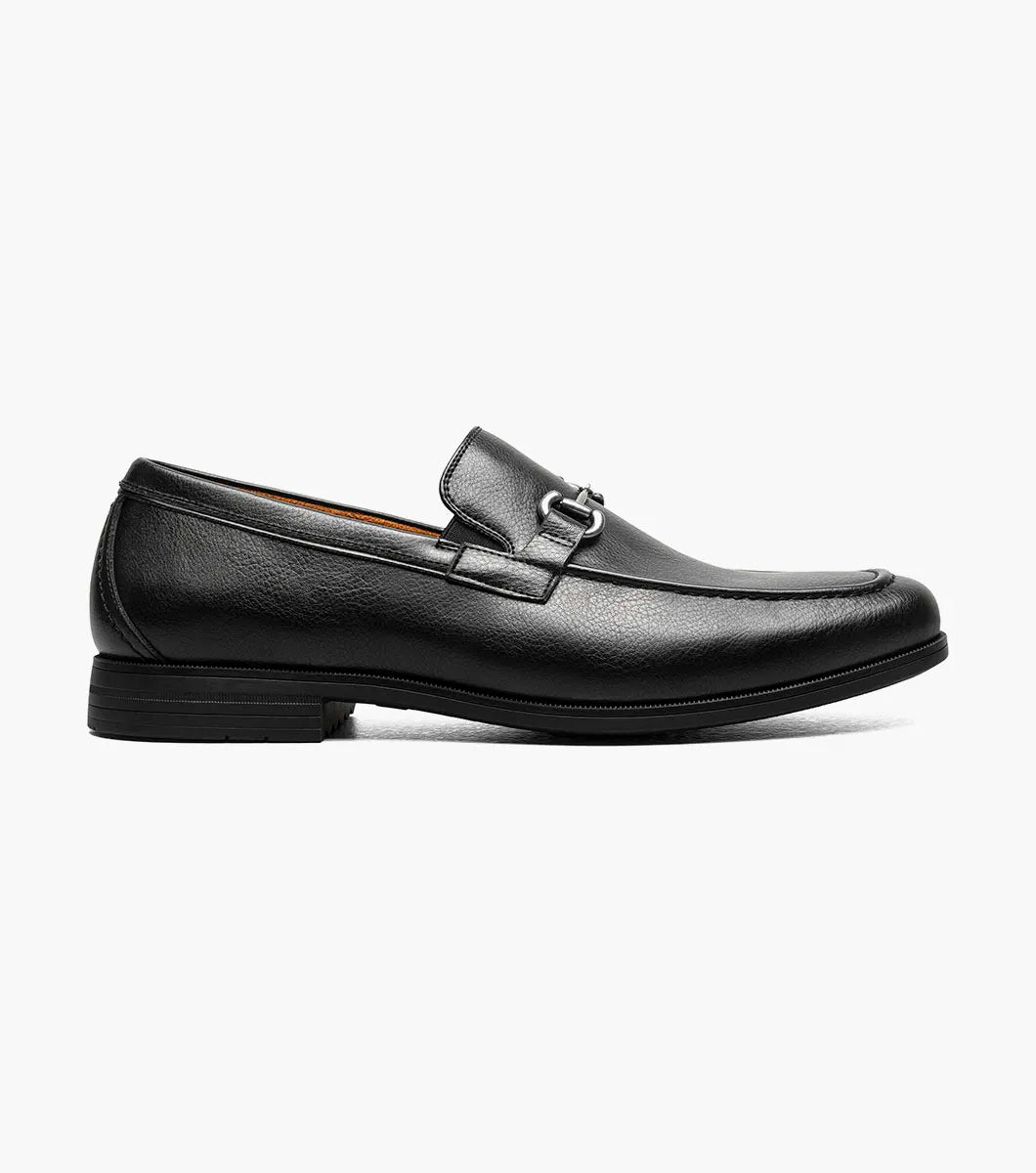 The STACY ADAMS Richmont Moc Toe Bit Slip On in Black Tumbled (21567-007) features black leather, a metal bit detail, low heel, and brown lining—shown here as a stylish dress casual loafer on a white background.