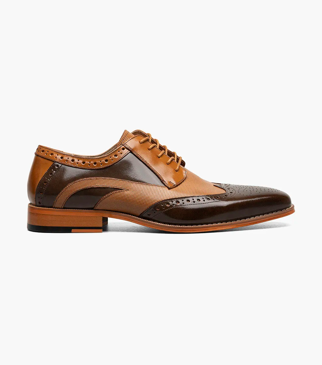 The Stacy Adams Ivingale Wingtip Oxford (Brown Multi, style 25684-249) features brogue detailing, laces, a memory foam footbed, and a low stacked heel. Shown in two-tone brown leather against a white background.