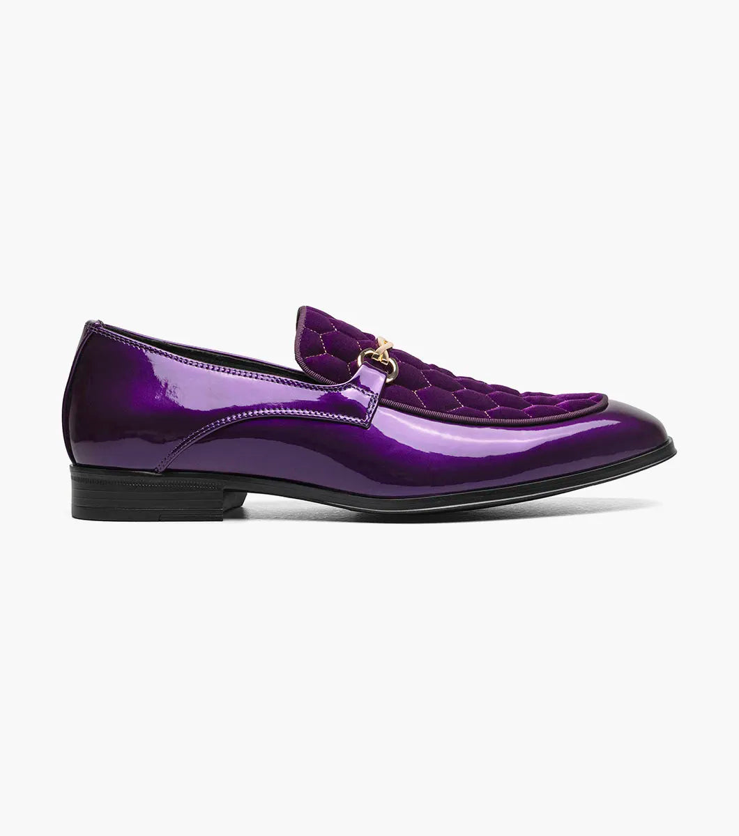 The STACY ADAMS Sprague Moc Toe Bit Slip On (25732-542) is a glossy purple loafer with a hexagonal quilted velvet upper, gold metal bit detail, and memory foam insole for comfort.