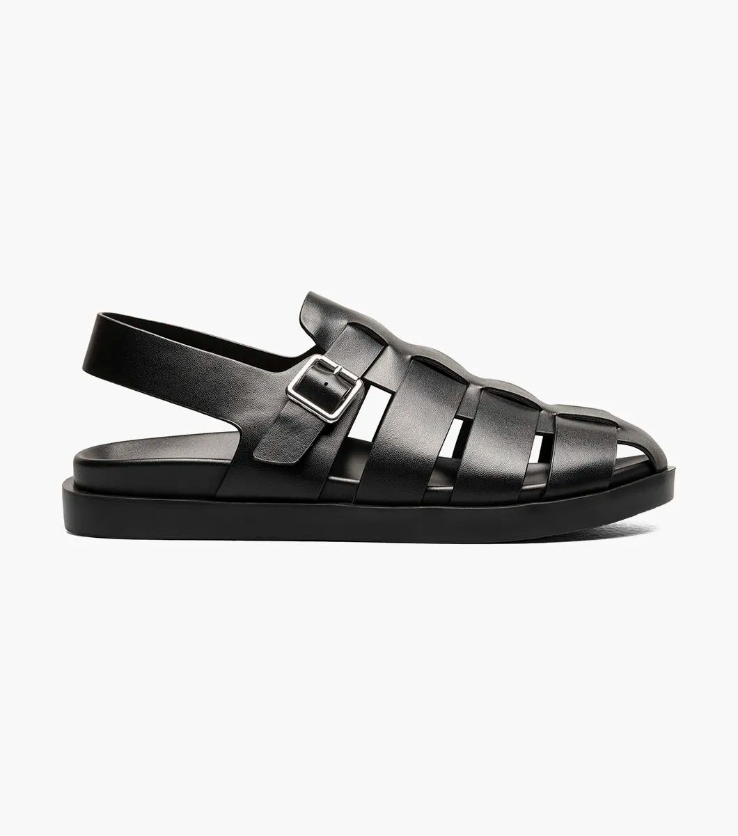 A black STACY ADAMS Montego Slingback Buckle Sandal (25659-001) with a closed toe, cushioned EVA midsole, and buckle strap is shown in profile against a white background.