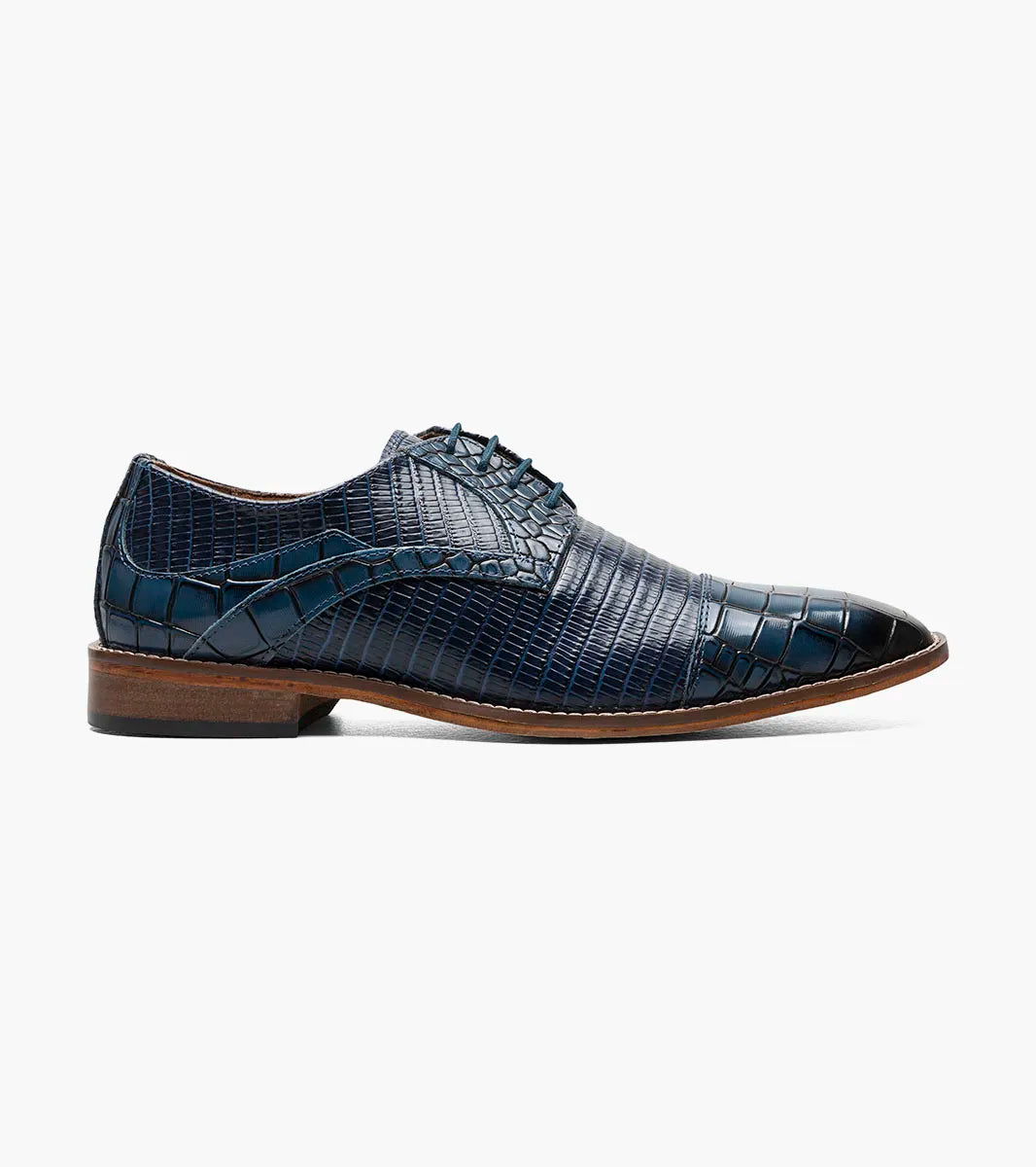The Stacy Adams Tedesco Cap Toe Oxford (25630-400) is a blue crocodile print leather dress shoe with a RedZone footbed, brown sole, and laces shown on a white background.