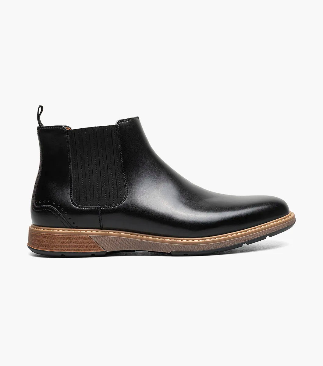 The STACY ADAMS Platt Plain Toe Chelsea Boot (Black, 25755-001) features sleek leather, elastic side panels, a brown sole, and a back pull tab—an elegant choice for any men’s boot collection.