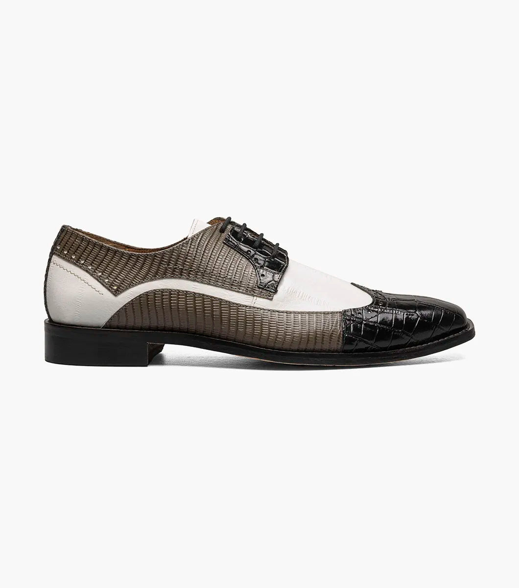 The Stacy Adams Gallinari Wingtip Lace Up (25660-910) is a men’s leather dress shoe in black and grey with off-white panels, textured pattern, cushioned footbed, and lace-up closure, shown on a white background.