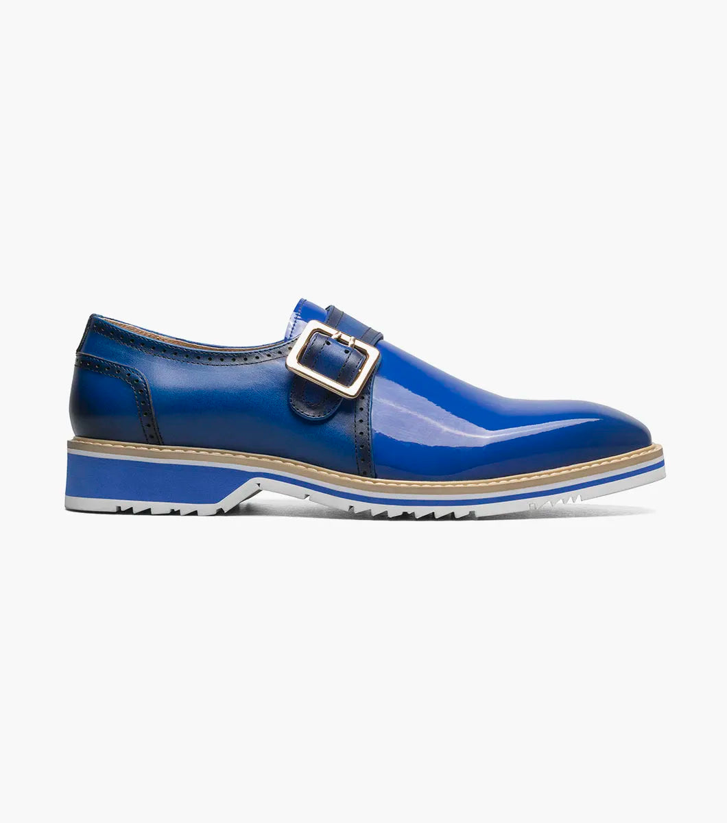 The Stacy Adams Bartram Plain Toe Monk Strap (25724-400) features a shiny blue leather upper, silver buckle, white sole, and tan midsole. Displayed in profile against a plain white background.