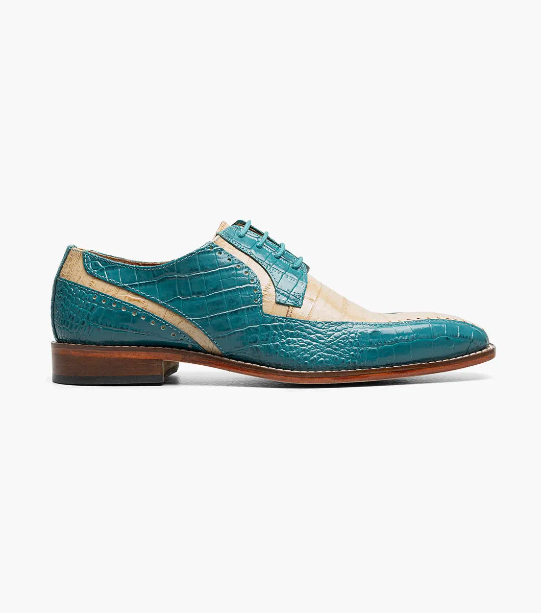 The Stacy Adams Talamanco Bike Toe Oxford in Teal Multi (Style 25788-448) features a sophisticated blend of teal blue and beige crocodile-textured leather, detailed with classic broguing and set atop a brown sole—combining timeless elegance with everyday comfort for any occasion.