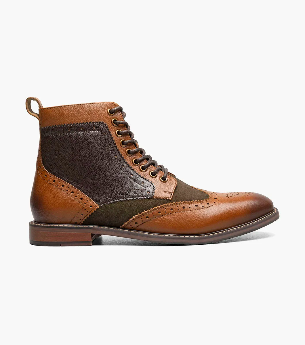 The STACY ADAMS Finnegan Wingtip Lace Up Boot in Olive Multi features brown leather and olive green textile, brogue detailing, a memory foam insole, and a low heel, shown against a white background.