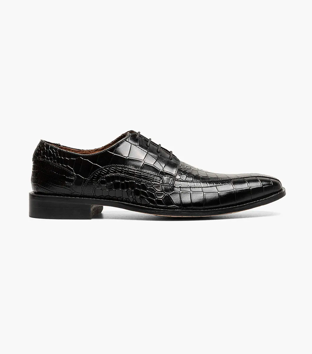 The STACY ADAMS Gabardo Bike Toe Oxford in black (25681-001) is a crocodile-textured leather dress shoe with lace-up closure, a low heel, and memory foam cushioning for comfort, shown on a white background.
