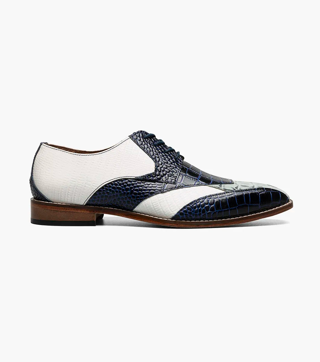 The Stacy Adams Tristano Modified Bike Toe Oxford in Dark Blue Multi features white leather, blue crocodile print leather, lace-up design, RedZone footbed, and a brown sole.