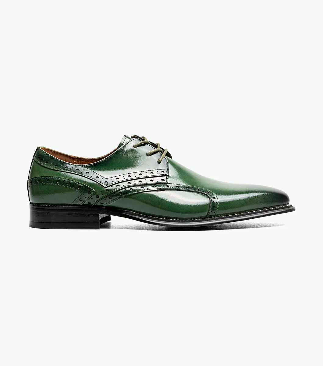 The Stacy Adams Alexander Plain Toe Oxford (25791-300) in polished green calf leather features decorative stitching and perforations, classic laces, a low black heel, and a comfortable Memory Foam insole—all showcased against a plain white background.