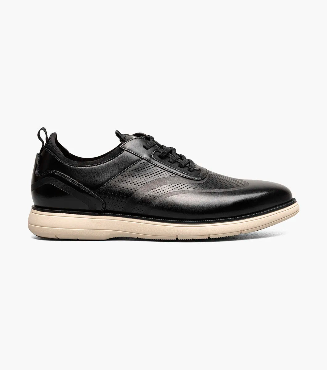 The Stacy Adams Edgewood Wingtip Elastic Lace Up in Black features perforated detailing, anatomical arch support, and a light beige sole. This STACY ADAMS dress shoe combines classic style with athletic comfort.
