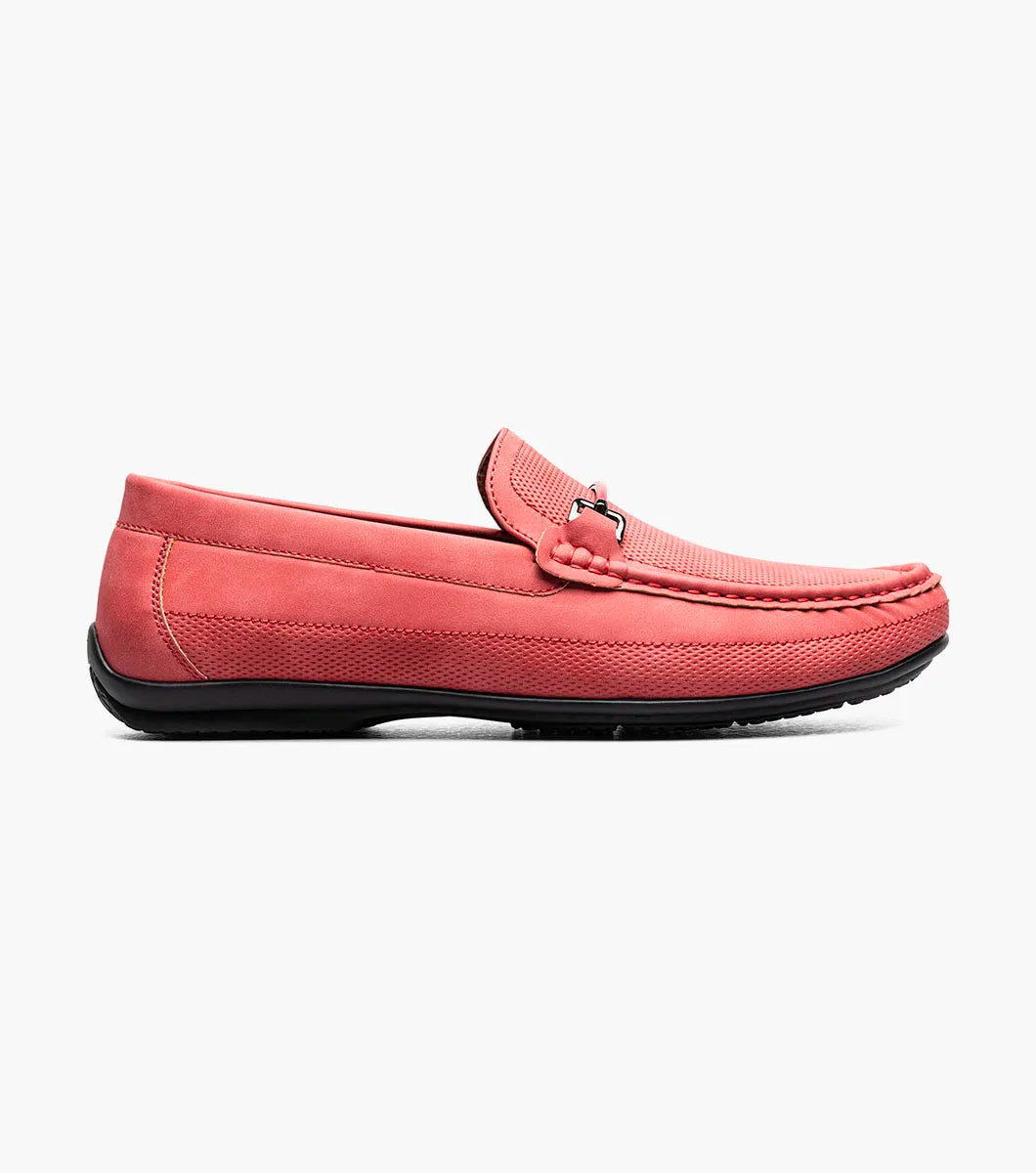 The Stacy Adams Colton Moc Toe Bit Slip On (25760-600) is a red suede loafer featuring a metal bit detail, visible stitching, black sole, striped inner lining, and cushioned footbed for comfort.