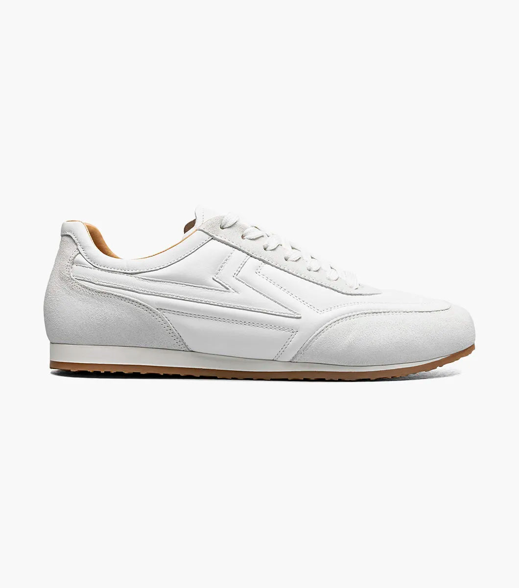Introducing the Stacy Adams Action 150 Sporty Lace Up in White (style 25797-100), these men’s sneakers from STACY ADAMS feature a low-top silhouette with white laces, suede accents around the toe, a gum sole, and a subtle embossed design on the side. Photographed on a clean white background, these casual sneakers offer timeless style and sporty details for versatile everyday wear.